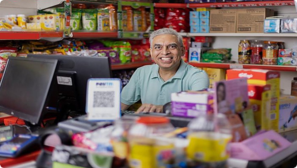 A store owner at the counter of his convenience store